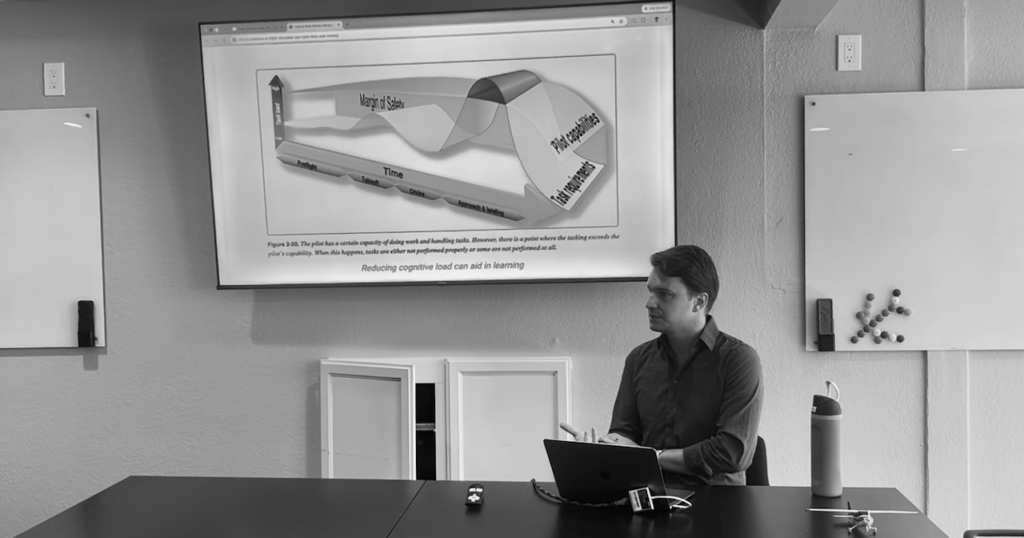 Jack in front of presentation currently displaying cognitive load graph